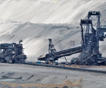 a bucket wheel excavator in a coal mine in grayscale photography